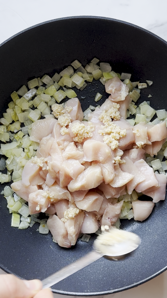 diced onions and cut up chicken and garlic